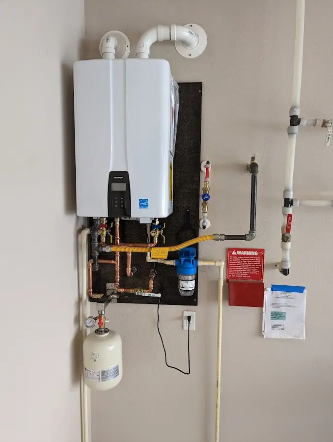 Professional plumber installing copper piping in a Crown Point home